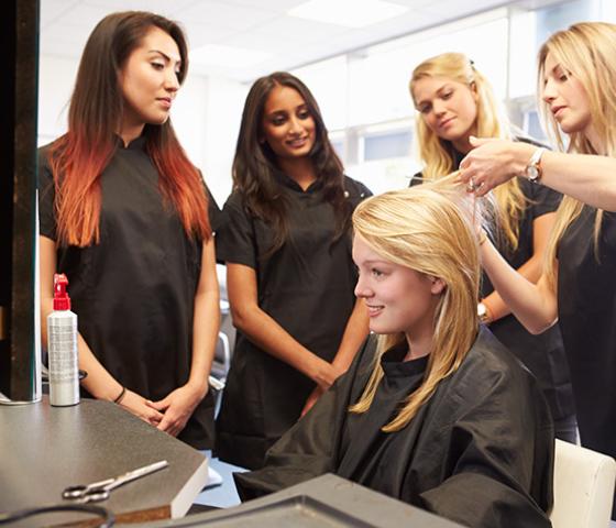 Decorative image - apprentice hairdressers learning from salon manager