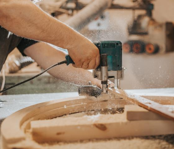 Decorative image - Man using saw to cut wood