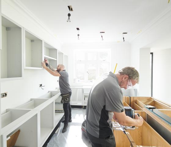 Decorative image - man making cupboard in kitchen